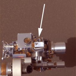 This image from NASA's Mars Exploration Rover, Opportunity, shows its microscopic imager (circular device) in the middle against the red-hued martian landscape. The microscopic imager is located on the rover's instrument deployment device, or arm.