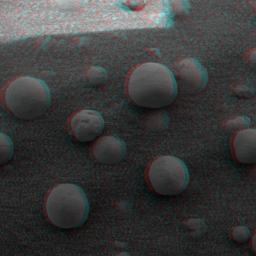 This is 3-D anaglyph, from NASA's Mars Exploration Rover Spirit, shows an extreme close-up of round, blueberry-shaped grains on the crater floor near the rock outcrop at Meridiani Planum called Stone Mountain. 3D glasses are necessary.