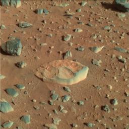 This image from NASA's Mars Exploration Rover Spirit shows the red-green-blue rock called White Boat, light in color and more tabular shape compared to the dark, rounded rocks that surround it. 