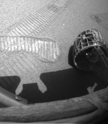 This image shows NASA's Mars Exploration Rover Opportunity's digging a hole in the ground at Meridiani Planum, Mars. The rover scraped its front right wheel back and forth across the surface six times by rotating its whole body in place.