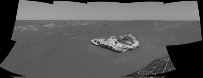 The wheel tracks seen above and to the left of the lander trace the path NASA's Mars Exploration Rover Opportunity has traveled since landing in a small crater at Meridiani Planum, Mars.