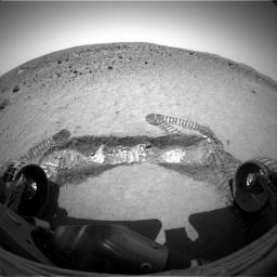 A view from NASA's Spirit rover shows a trench excavated by the rover's left front wheel within the 'Laguna Hollow' area. The trench, dubbed 'Road Cut,' is 3 inches deep. Spirit's tracks are observed on the martian soil.