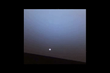 NASA's Mars Exploration Rover Opportunity watches a sunset on a martian afternoon. Rapid dimming of the Sun near the horizon is due to the dust in the sky. Dust in the martian atmosphere scatters blue light forward creating a'halo' of blueish sky color.