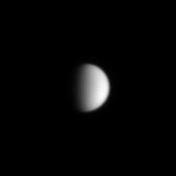 Titan's featureless atmosphere as seen in visible light glares back at the viewer, challenging NASA's Cassini and its piggybacked Huygens probe to expose the moon's many secrets.
