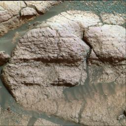NASA's Mars Exploration Rover Opportunity, shows a close up of the rock dubbed 'El Capitan,' located in the rock outcrop at Meridiani Planum. Seen are fine, parallel lamination in the upper area of the rock, and scattered sphere-shaped objects.