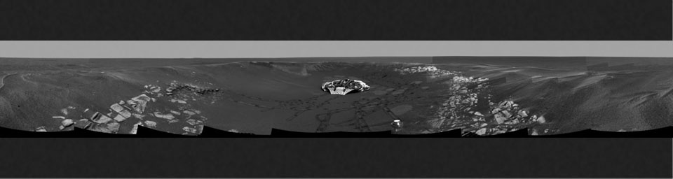 This image from NASA's Mars Exploration Rover Opportunity shows a panoramic view of the crater informally referred to as 'Eagle Crater,' which is approximately 72 feet in diameter. Opportunity's lander and track marks are visible.