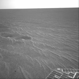 This image from NASA's Mars Exploration Rover Opportunity is part of the first set of pictures that was returned to Earth after the rover exited 'Eagle Crater.' Plentiful ripples are seen on the plains and two depressions featuring bright spots.
