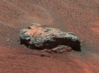 This image from NASA's Mars Exploration Rover Opportunity shows 'Bounce Rock.' There appears to be a dusty coating on the top of parts of the rock, which may have been broken when it was struck by the airbags while rolling to a stop.