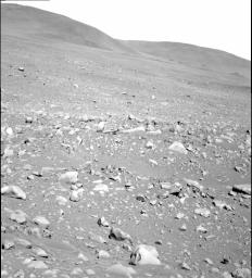 NASA's Mars Exploration Rover Spirit took this gray-scale panoramic camera image of the 'Columbia Hills' on sol 107 (April 21, 2004). The hills are seen rising above a rocky martian surface in the foreground.
