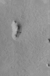 NASA's Mars Global Surveyor shows three small buttes in the Memnonia Sulci region of Mars. The buttes are remnants of formerly more extensive layered rock that once covered the region.
