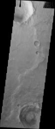 This image from NASA's 2001 Mars Odyssey released on April 19, 2004 shows gray hematite and rampart craters near the Aram Chaos Region on Mars.