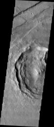 This image from NASA's 2001 Mars Odyssey released on April 21, 2004 shows a large crater on Mars in Memnonia Fossae that contains lobates situated on the mid-left hand side of the image.