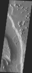 This image from NASA's 2001 Mars Odyssey released on April 26, 2004 shows a bend in the river in Tiu Vallis on Mars.