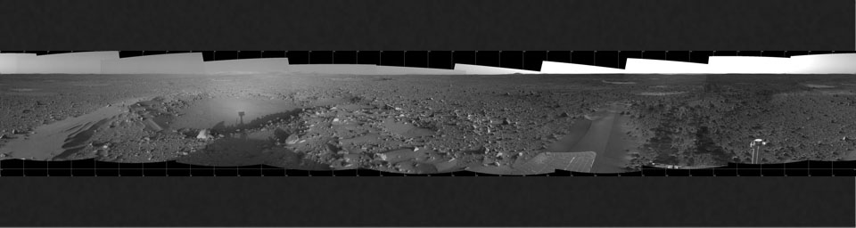 This 360-degree panorama taken by NASA's Mars Exploration Rover Spirit highlights the bumpy terrain surrounding the rover. Spirit's shadow can be seen in a small hollow lying between the rover and its intended target, the eastern-lying 'Columbia Hills.'