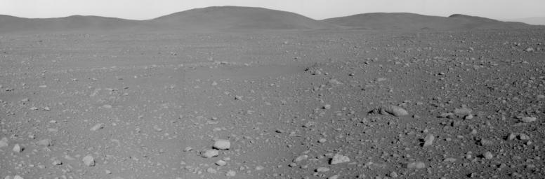 NASA's Mars Exploration Rover Spirit took this panoramic camera image mosaic of the 'Columbia Hills' May 7, 2004. Spirit spent the next 37 sols or more approaching the base of the highest peak seen in this image.