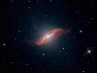 This image taken by NASA's Spitzer Space Telescope shows in unprecedented detail the galaxy Centaurus A's last big meal: a spiral galaxy seemingly twisted into a parallelogram-shaped structure of dust. 
