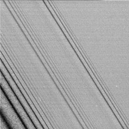 This image shows three density waves in Saturn's A ring. It was taken by the narrow angle camera on NASA's Cassini spacecraft after successful entry into Saturn's orbit.
