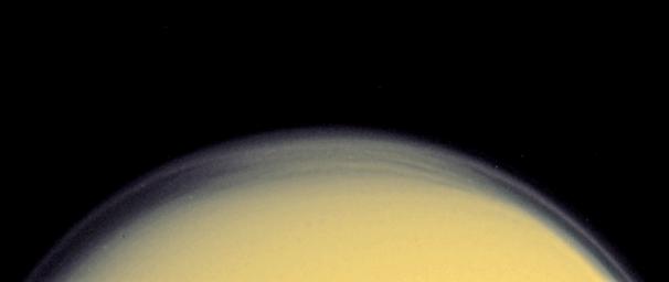 A global detached haze layer and discrete cloud-like features high above Titan's northern terminator (day-night transition) are visible in this close-up image captured by NASA's Cassini spacecraft.