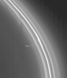 As it completed its first orbit of Saturn, NASA's Cassini spacecraft zoomed in on the rings to catch this wondrous view of the shepherd moon Prometheus working its influence on the multi-stranded and kinked F ring.