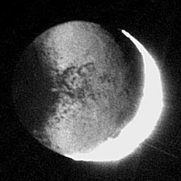 New details on Iapetus are illuminated by reflected light from Saturn in this revealing image captured by NASA's Cassini spacecraft.