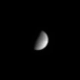NASA's Cassini spacecraft sighted the far-off icy moon Tethys as it headed back toward Saturn in its long, looping first orbit of the planet.