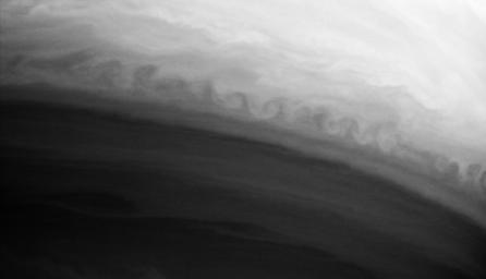 This turbulent boundary between two latitudinal bands in Saturn's atmosphere curls repeatedly along its edge in this image from NASA's Cassini spacecraft.