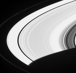 This image captured by NASA's Cassini spacecraft shows Saturn's moon Pan just after the little moon emerged from Saturn's shadow.