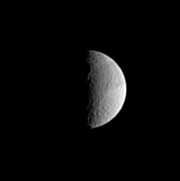 The eastern rim of the large crater Odysseus is visible along the terminator in this image of Saturn's moon Tethys, captured by NASA's Cassini spacecraft.