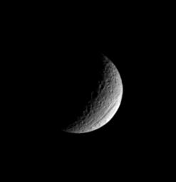 Ithaca Chasma is one of the two most prominent features on Saturn's moon Tethys; the other is the gigantic crater Odysseus. Ithaca Chasma is visible near the moon's lower right limb in this image captured by NASA's Cassini spacecraft.