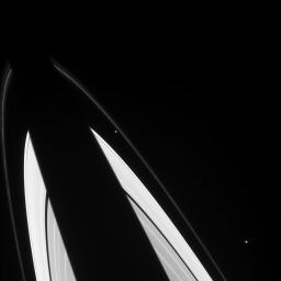 The oddball shapes of Saturn's small ring moons Prometheus and Epimetheus are discernible in this image from NASA's Cassini spacecraft.