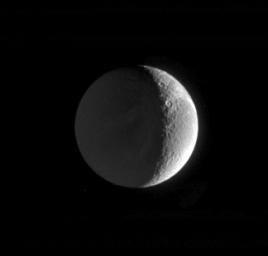 This image captured by NASA's Cassini spacecraft shows the night side of Saturn's moon Dione on Feb. 18, 2005.