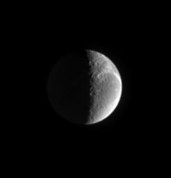 The Sun also rises on Saturn's moon Dione, seen in this image from NASA's Cassini spacecraft. Wispy fractured terrain lies along the limb taken on March 12, 2005.