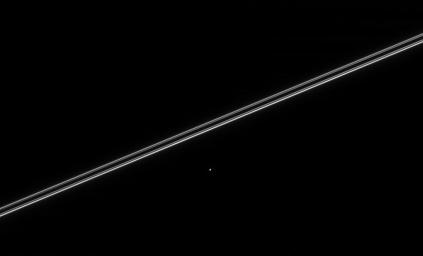 Saturn's moon Helene, seen here with Saturn's nearly edge-on rings, orbits 60 degrees ahead of Dione and is called a 'Trojan' moon. This image was taken in visible light with NASA's Cassini spacecraft's narrow-angle camera on March 12, 2005.