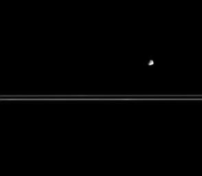 Small and asteroid-like in appearance, Epimetheus is seen here with Saturn's nearly edge-on rings in the distance. This image was taken in visible light with NASA's Cassini spacecraft's narrow-angle camera on March 12, 2005.