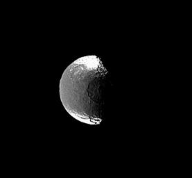 This image from NASA's Cassini spacecraft shows one of the huge impact basins on the terminator of Saturn's moon Iapetus and a smaller, but still fairly large, crater near the southern bright-dark boundary.