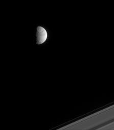 Two large impact basins, including the 450-kilometer-wide Odysseus basin, mark the face of Saturn's moon Tethys, as shown in this image from NASA's Cassini spacecraft.