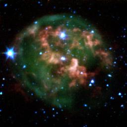 This false-color image from NASA's Spitzer Space Telescope shows a dying star (center) surrounded by a cloud of glowing gas and dust.