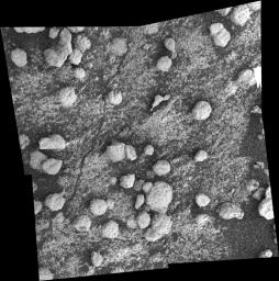 This mosaic, featuring the rock target dubbed 'Bylot,' was acquired by NASA's Mars Exploration Rover Opportunity on Aug. 9, 2004. Seen are spherules and dark sand partially covering rock.