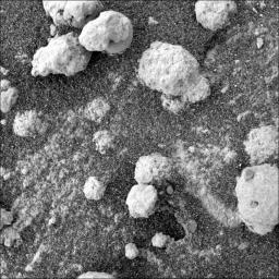 This view from the microscopic imager on NASA's Mars Exploration Rover Opportunity shows a type of light-colored, rough-textured spherules scientists call 'popcorn' in contrast to the darker, smoother spherules called 'blueberries.'