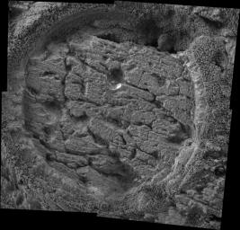 This image taken by NASA's Mars Exploration Rover Opportunity shows a target dubbed 'Grindstone' on a rock called 'Manitoba' in 'Endurance Crater.' Opportunity dug a hole into the target with its rock abrasion tool.