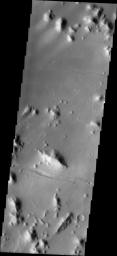 This image released on August 12, 2004 from NASA's 2001 Mars Odyssey shows Tartarus Montes. The small hills and ridges in this image are the montes (mountains) of the Tartarus region of Mars.