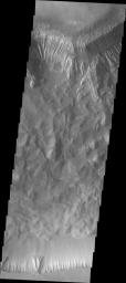 This image from Sept 1, 2004 from NASA's 2001 Mars Odyssey shows Hebes Chasma on Mars, part of a smaller chasma system located north of the main Valles Marineris with both walls of the canyon visible. Chasma is a deep, elongated, steep-sided depression.