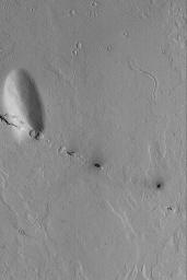 NASA's Mars Global Surveyor shows a small line of collapsed pits that follow the trend of the regional Cerberus Fossae troughs on Mars.