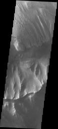 This image released on Sept 23, 2004 from NASA's 2001 Mars Odyssey shows a hill formation on Mars separating Ophir and Candor Chasmas and an interesting wind etched rock formation in Ophir Chasma.