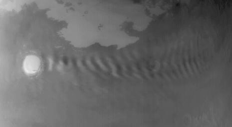 NASA's Mars Global Surveyor shows a wavy cloud pattern formed in the lee of Korolev Crater on Mars.