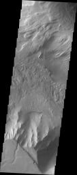 This image released on Sept 30, 2004 from NASA's 2001 Mars Odyssey shows an area on Mars in Candor Chasma. Wind etched surfaces, dunes and layered rock are present in this area. A land slide can be seen on the left-center portion of this image. 