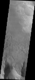 This image released on Oct 1, 2004 from NASA's 2001 Mars Odyssey shows an area on Mars in Candor Chasma.Two large landslides are visible (in the center and at the right edge). The northern part of the image shows a large sand filled area.