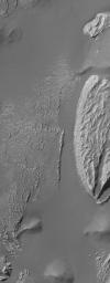 NASA's Mars Global Surveyor shows light-toned rock outcrops, possibly sedimentary rocks, in the Arsinoes Chaos region east of the Valles Marineris trough system. These rocky materials were once below the martian surface.