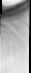 This image released on Oct 29, 2004 from NASA's 2001 Mars Odyssey shows the Martian north polar cap. Streamers of dust moving downslope over the darker trough sides showing the laminar flow regime coming off the cap. 