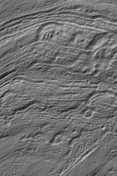 NASA's Mars Global Surveyor shows the odd patterns of erosion on the floor of Reull Vallis, a major valley system in the martian southern hemisphere. Circular features may have been meteor craters that were eroded and deformed by erosive processes.
